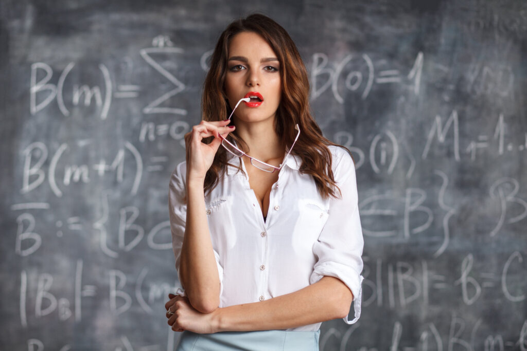Smart Sexy Female Teacher In Eyeglasses Near Blackboard